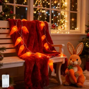 Vista detallada de luces de zanahoria en manta roja con un adorable conejo de peluche.