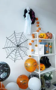 Halloween decoration set featuring spider web LED string lights and festive props for parties.