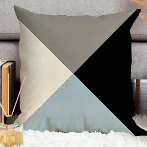 Geometric pillow cover abstract print detail shot showing clean color block lines and soft fabric.