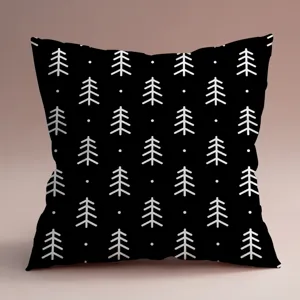 Gros plan sur la housse de coussin carrée noire avec un motif d'arbre de pin minimaliste blanc.