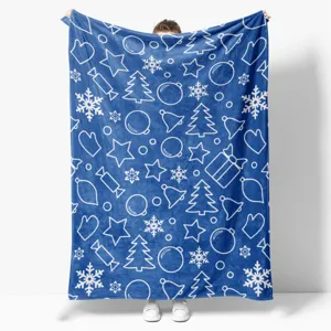 Blue Christmas flannel blanket with white holiday pattern, held by person, main view display