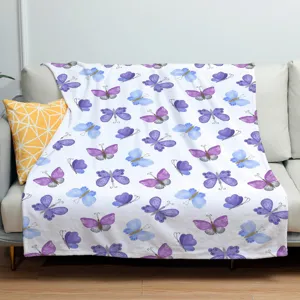 Soft purple butterfly pattern flannel blanket detail showing watercolor print design on sofa.