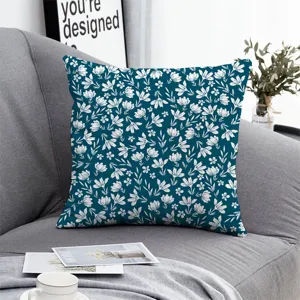 Floral throw pillow cover detail, dark blue fabric with white botanical pattern, cozy home decor.