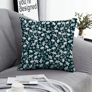 Close-up of dark green floral throw pillow cover on grey sofa, aesthetic room decor detail.