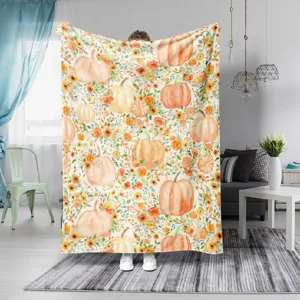 Vista detallada de la acogedora manta de franela con calabazas de Halloween y motivo floral