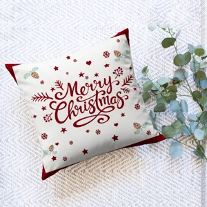 Christmas throw pillow cover detail showing festive typography print and holiday pine cone patterns.