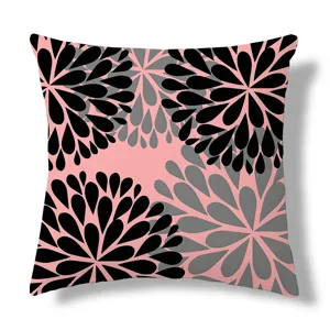 Close-up detail of the modern geometric floral cushion cover with stylish black and pink pattern.