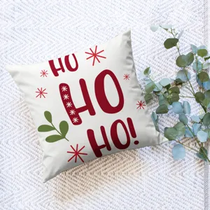 Christmas square throw pillow cover with festive red HO HO HO print and green leaf decor.