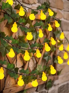 Solar gourd string lights with green ivy leaves for courtyard balcony garden decoration.