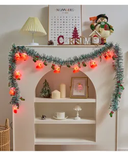 Christmas tinsel garland with red boot string lights displayed on a cozy white mantelpiece.