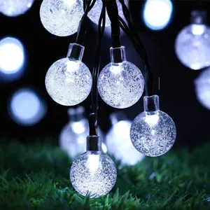 Primo piano di luci a stringa con bolle di cristallo, perfette per decorare giardini notturni.