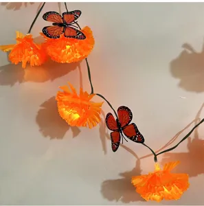 Solar LED string lights with marigolds and butterfly decorations for Halloween and parties.