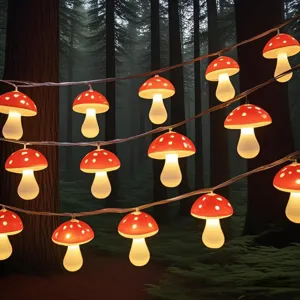 Close-up detail of glowing red mushroom LED string lights hanging in a dreamy forest setting.