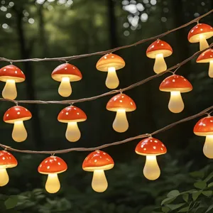 Close-up detail of glowing red toadstool fairy lights strung in outdoor forest setting warm glow