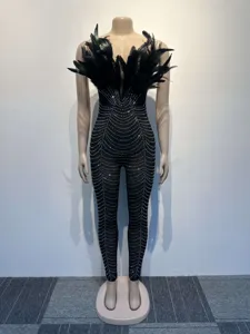 Detailed view of the black feather strapless jumpsuit featuring dazzling rhinestone lines.
