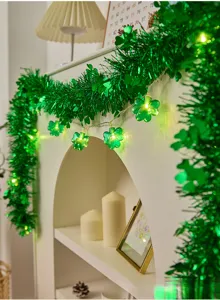 St. Patrick's Day green tinsel garland with glowing four-leaf clover LED string lights.