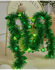 St. Patrick's Day green tinsel garland with clover LED string lights for party decor.