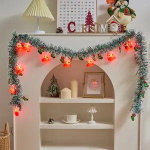 Christmas tinsel string lights with colorful glowing sock pendants for holiday mantle decor.