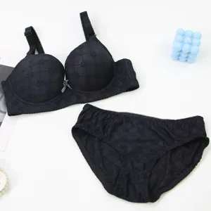 Black push-up bra and panties set with subtle check pattern and bow detail for women.
