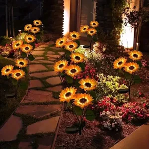 Outdoor solar sunflower garden light glowing along pathways for yard and lawn night decor.