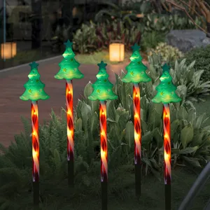 Solar Christmas tree lawn stakes with candy cane poles and warm LED lights for yard decor