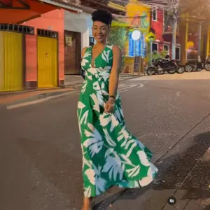Detail shot of women's green floral sleeveless deep V-neck maxi dress with waist cinching.