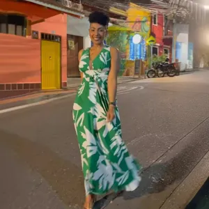 Detail view of the elegant sleeveless v-neck floral print maxi dress in night street scene.