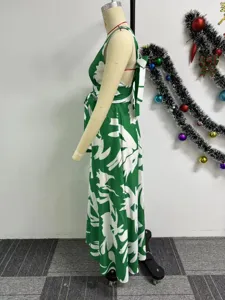 Side detail view of the green abstract floral print sleeveless maxi dress featuring elegant waist tie.