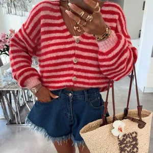 Women red pink striped v-neck long sleeve knit cardigan sweater with denim shorts outfit.