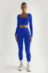 Μπλε ριμπ crop top με μακριμάνικο και ψηλόμεσο κολάν γυμναστικής σετ για γυναίκες.