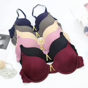 Detail view of multi-color seamless push-up underwire bras featuring chic metal V front decor.
