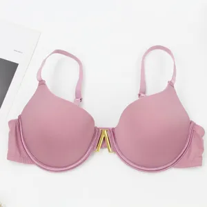 Detailed view of a stylish pink underwire push-up bra featuring elegant golden metal front clasp.