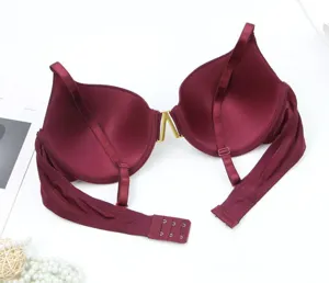 Close-up of wine red front metal buckle push-up bra detail showing underwire and cups.