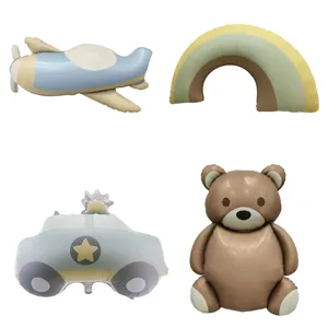 Collection of vintage matte foil balloons in bear, airplane, car, and rainbow shapes.