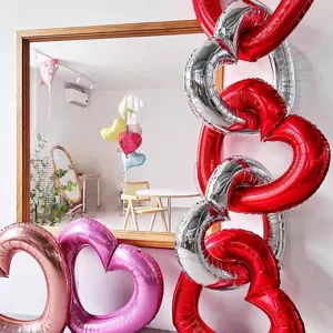 Detail view of linked red and silver heart-shaped foil balloons for party decor