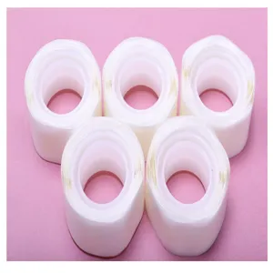 Detail shot showing five rolls of transparent double-sided adhesive balloon glue dots