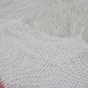 Detail shot of women's white knit sweater collar, stylish contrast color knitwear item.