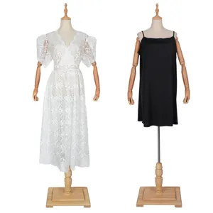 Detail view of women two piece lace dress with black slip inner wear on mannequin display.