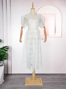 White lace V-neck dress detail, featuring delicate hollow floral pattern and short sleeves.