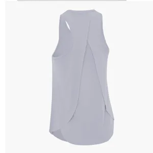 Women's solid color activewear tank top with crossover back design for yoga and running.