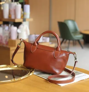 Vintage brown leather dumpling bag, versatile crossbody shoulder handbag for women daily wear.