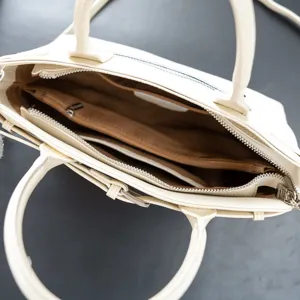 Detailed top-down view of the cream white leather tote bag interior compartments.