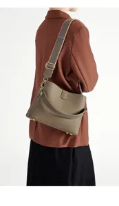 Elegant taupe leather crossbody bag for women, featuring a wide strap and chic top handle.