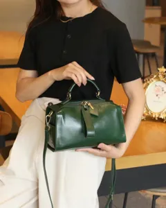 Genuine leather pillow bag detail, dark green retro style, top layer cowhide handbag view.