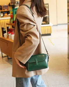 Green oil wax leather shell crossbody shoulder bag detail shot displaying retro texture