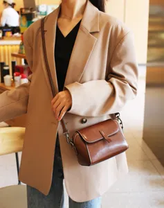 Vintage oil wax leather crossbody bag detail, elegant brown shoulder bag for everyday wear.