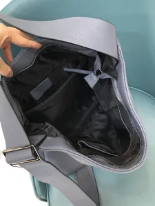 Leather hobo bag interior detail showing spacious compartment, black lining and zipper pocket.