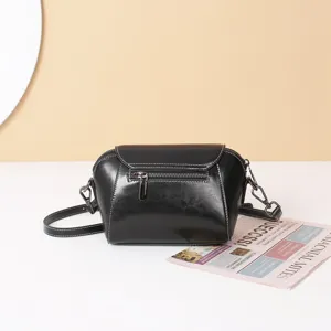 Black oil wax leather vintage shell bag detail shot, classic crossbody shoulder handbag for women.