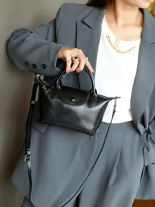 Stylish black genuine leather dumpling handbag for women, elegant crossbody and shoulder bag.