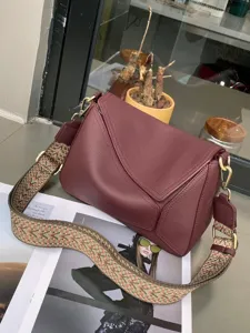 Burgundy genuine leather crossbody bag, stylish geometric flap design with wide shoulder strap.